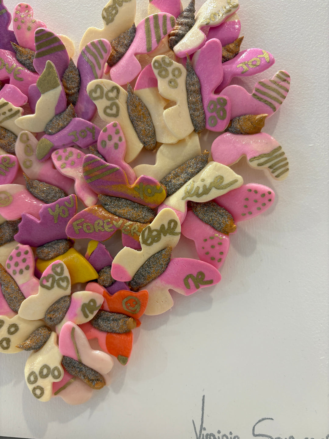 3 dimensional textured artwork of butterflies with text and floral collage on white background with pink and beige clay model paste acrylic in heart shape