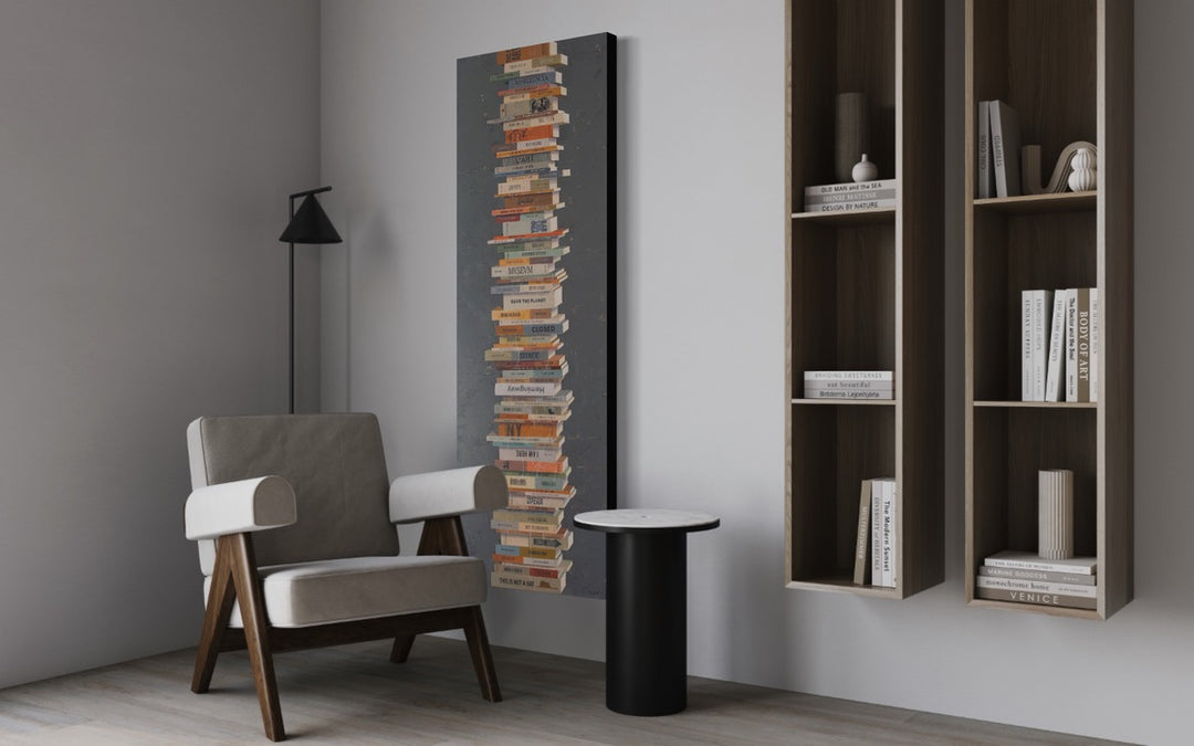 Books In Balance II, artwork by Tomasa Martín. Oil and acrylic on linen, vertical painting of stacked books on a charcoal gray bcackground.