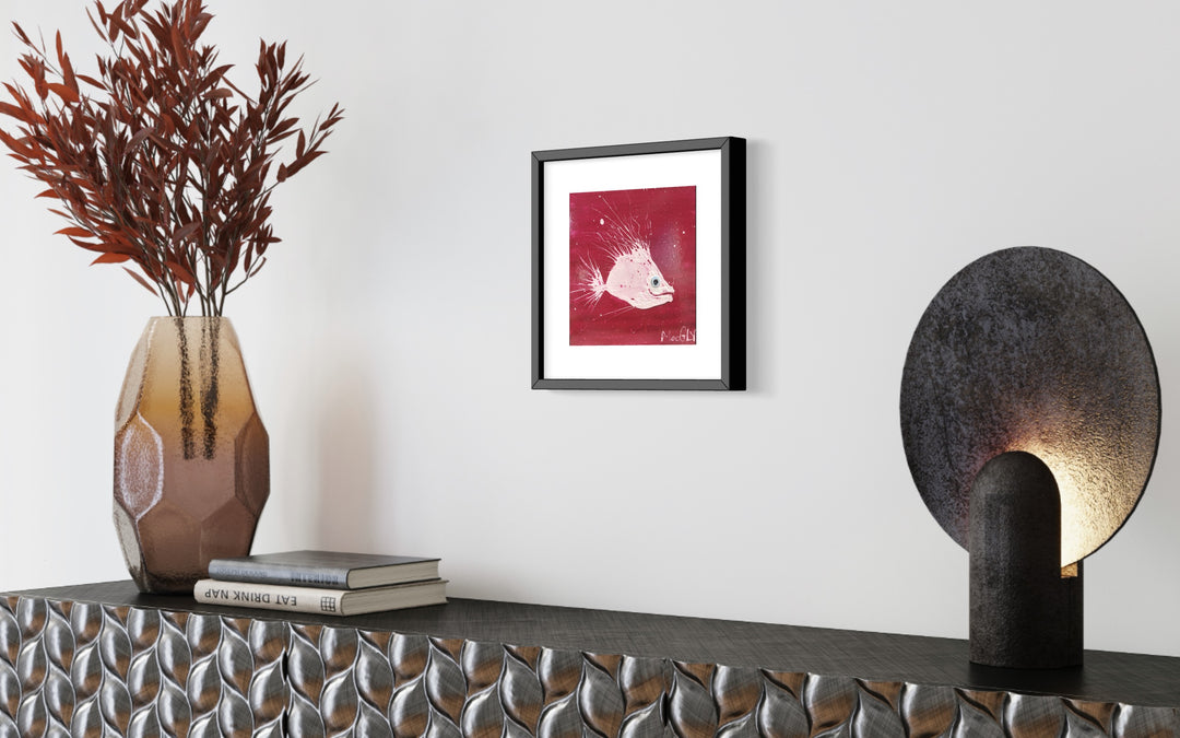 Frayed, artwork by Moogly, displayed in a home. Acrylic and collage on cardboard. 10 by 10 inches.